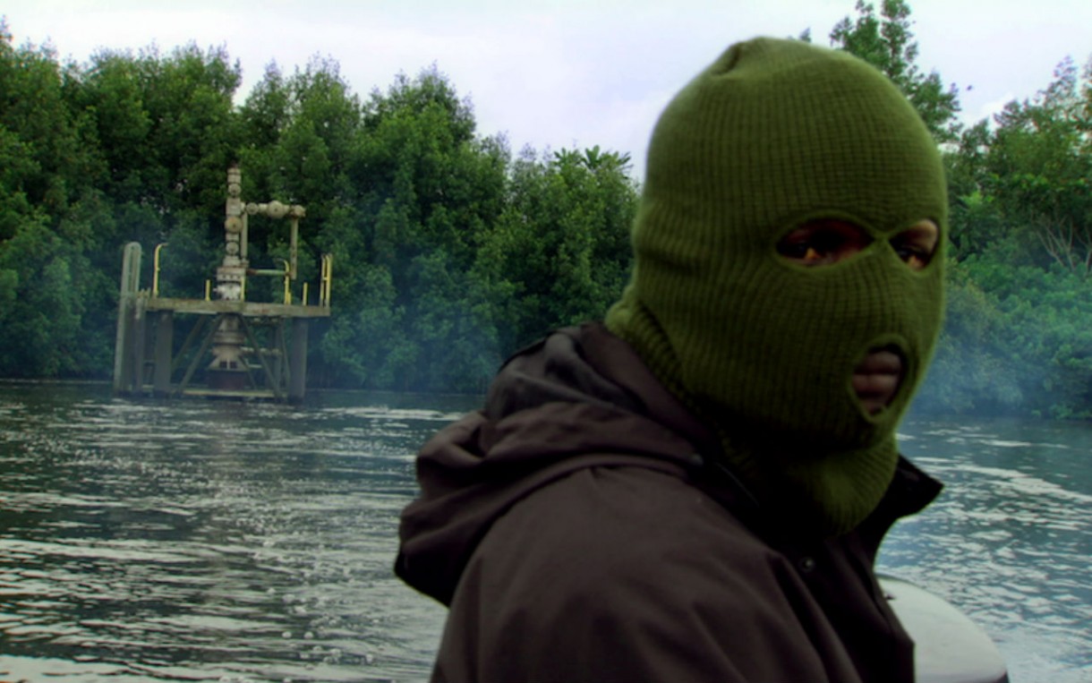 An armed militant in the Niger Delta appears in a scene from “Big Men.” Nigeria’s oil wealth hasn’t reduced the country’s poverty, leading to violence and unrest. Ghana is trying to avoid a similar outcome. Photo: Jonathan Furmanski