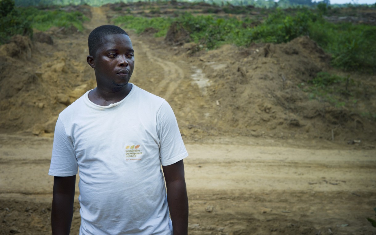 Daniel Krakue, who works for Social Entrepreneurs for Sustainable Development in Liberia, in a recently cleared part of the Butaw oil palm concession: “Nowadays we don’t have a specific month as to when the rain will start and when it will end. So that has caused serious problems as to how people will carry on their farming.” Photo by Anna Fawcus/Oxfam America.