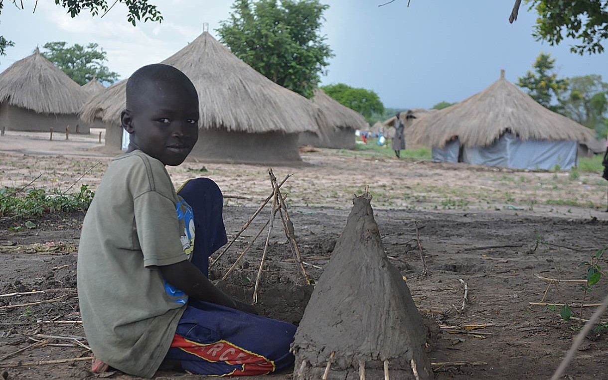 A South Sudanese boy living in the Odobu refugee settlement in Uganda plays with a toy hut he constructed. Photo: Dorah Ntunga/Oxfam