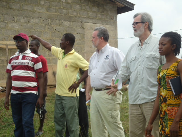 Oxfam Active Citizenship Advisor Abdulkarim Mohammed, (left, in red and white shirt), Oxfam President Ray Offenheiser (middle) and Oxfam Board Chair Joe Loughrey (with glasses) traveled in January to Ghana, where small-scale farmers, women’s organizations, and local citizen organizations are celebrating the government’s commitment to investing oil revenues in agriculture. Here they talk with community members at the Anglogold processing plant in Teberebie, Ghana. Photo: Enoch K. Norvor / Oxfam