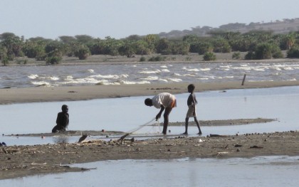 Children play in the water on the shore of Lake Turkana in Nasechabuin village of Northern Turkana. Photo: Caroline Gluck/Oxfam