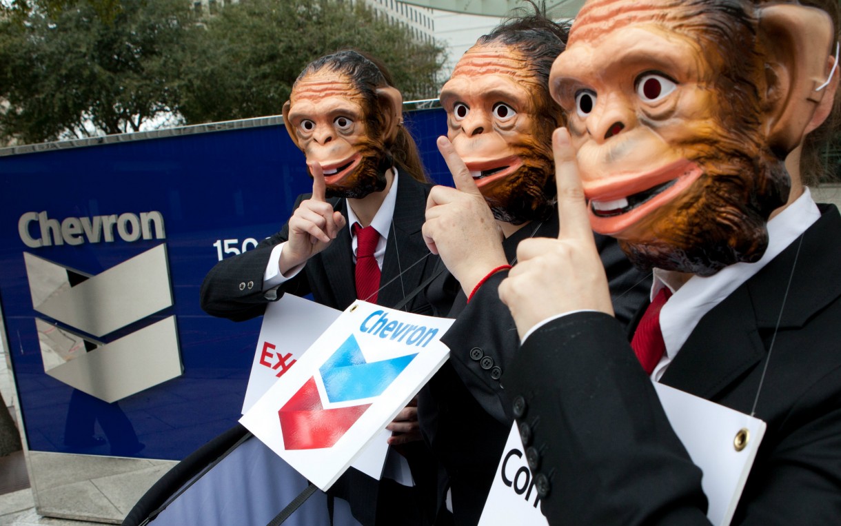 Activists outside the offices of Chevron in Houston, Texas call for oil companies to accept strong rules to implement the transparency provisions in the 2010 Dodd-Frank Wall Street Reform Bill. Portraying oil companies as monkeys in the "see no evil, speak no evil" proverb was a way to expose efforts by the oil industry to encourage the Securities and Exchange Commission to enact weak rules that will allow them to continue to make secret payments to governments. Photo: Scott Dalton / Oxfam America